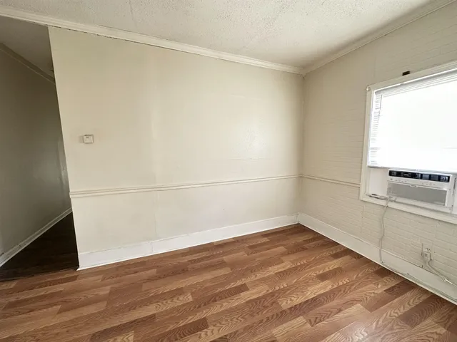 a view of a room with wooden floor