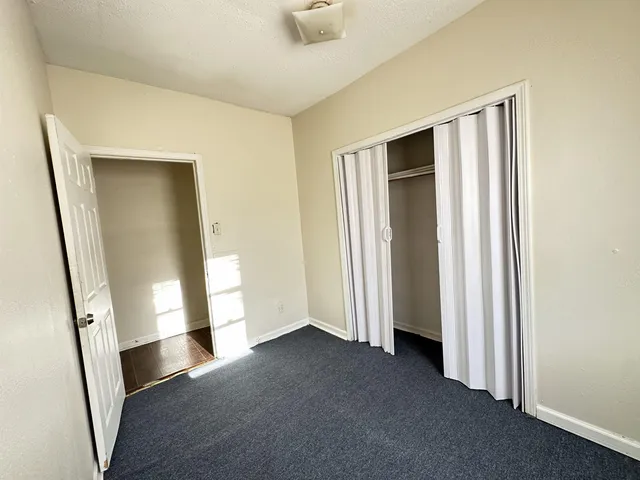 a bedroom with a bed and a sink