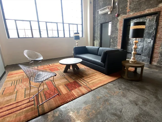 a living room with furniture and a rug
