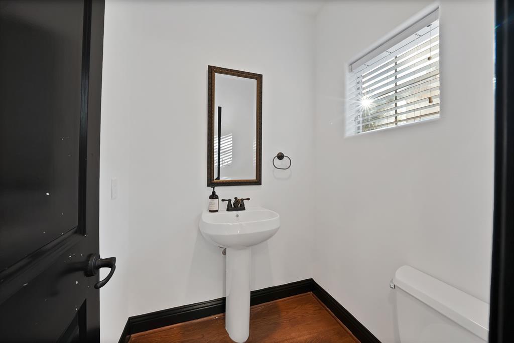 5747 Prospect Avenue, Unit B Dallas, TX 75206 - Photo 12 of 39 a bathroom with a sink toilet and a mirror