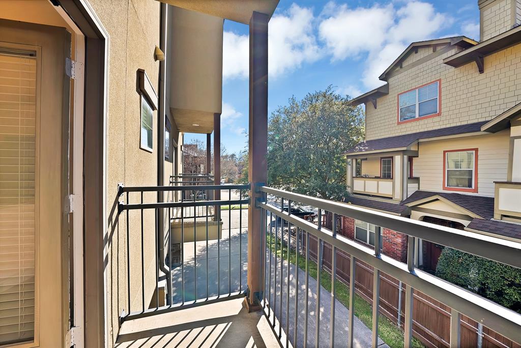5747 Prospect Avenue, Unit B Dallas, TX 75206 - Photo 15 of 40 a view of a balcony with a floor to ceiling window and wooden floor