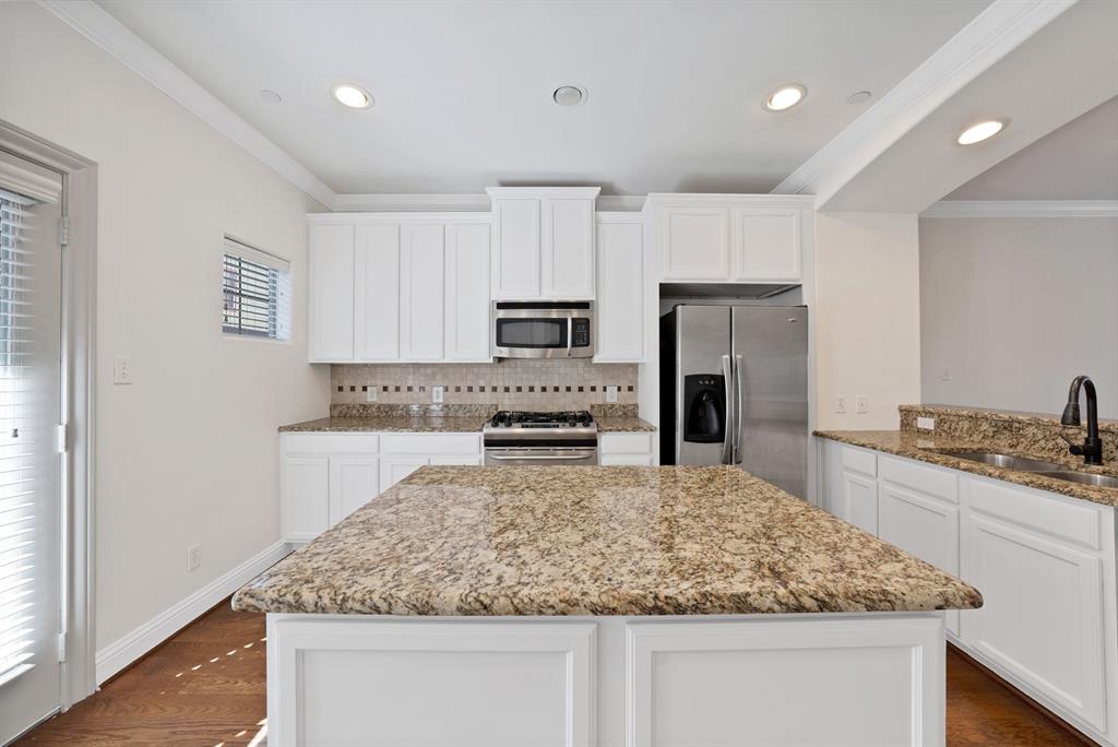 5747 Prospect Avenue, Unit B Dallas, TX 75206 - Photo 16 of 40 a kitchen with kitchen island granite countertop a sink stove and refrigerator