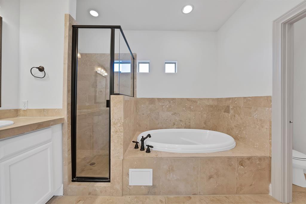 5747 Prospect Avenue, Unit B Dallas, TX 75206 - Photo 32 of 40 a bathroom with a tub a mirror and a shower