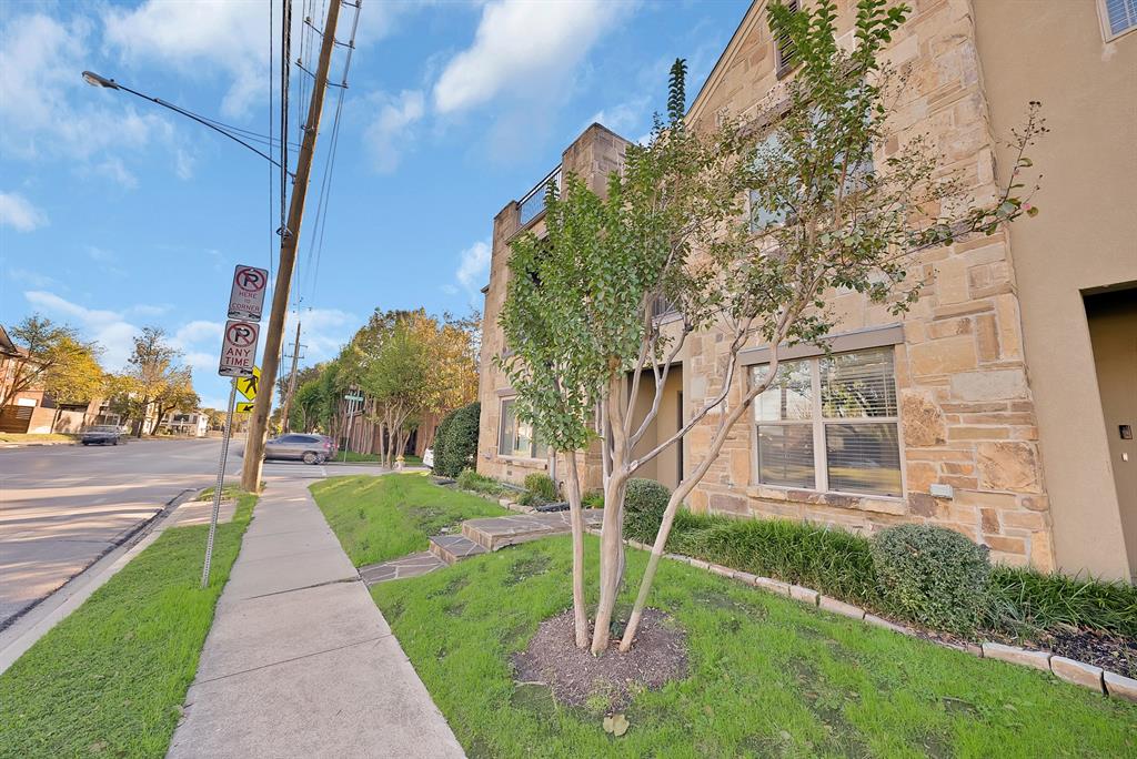 5747 Prospect Avenue, Unit B Dallas, TX 75206 - Photo 4 of 39 a view of a brick house with a small yard plants and a large tree