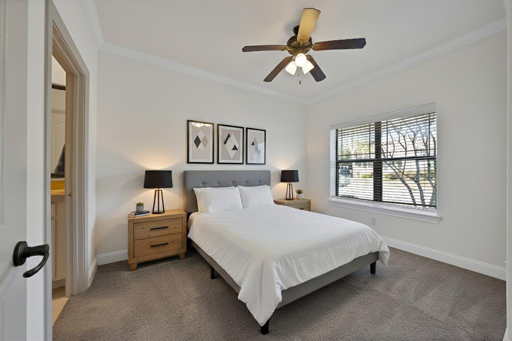 5747 Prospect Avenue, Unit B Dallas, TX 75206 - Photo 5 of 40 a bedroom with a bed a window and a chandelier