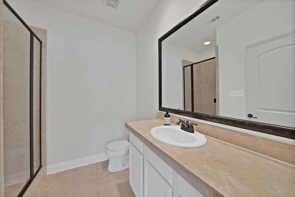 5747 Prospect Avenue, Unit B Dallas, TX 75206 - Photo 7 of 40 a bathroom with a granite countertop sink and a mirror
