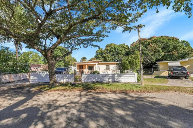 a view of a house with a yard and sitting area