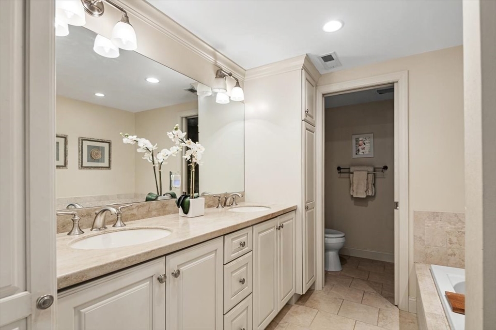 74 Thistle Patch Way, Unit 74 Hingham, MA 02043 - Photo 12 of 22 a bathroom with a granite countertop sink mirror and a toilet