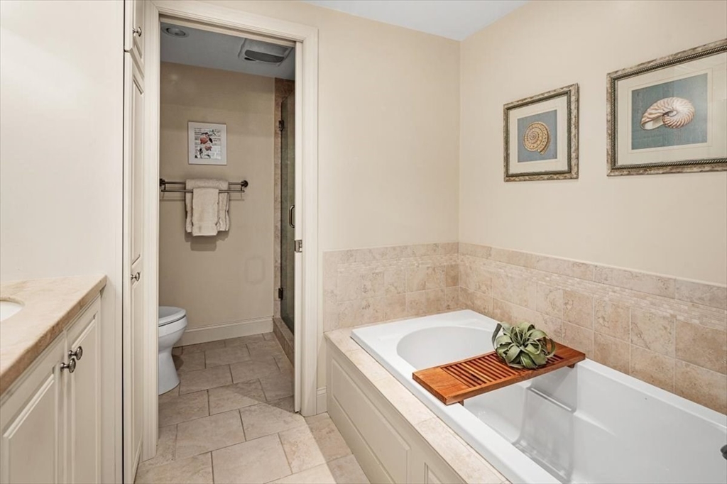74 Thistle Patch Way, Unit 74 Hingham, MA 02043 - Photo 13 of 22 a bathroom with a granite countertop tub sink and toilet