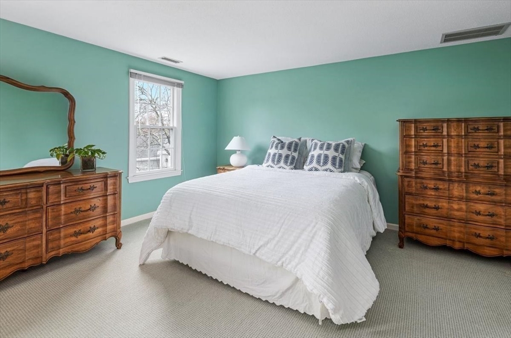 74 Thistle Patch Way, Unit 74 Hingham, MA 02043 - Photo 14 of 22 a bedroom with a bed and a dresser