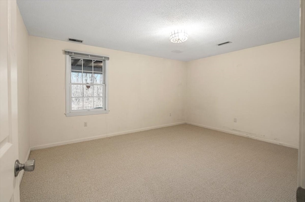 74 Thistle Patch Way, Unit 74 Hingham, MA 02043 - Photo 18 of 22 an empty room with a empty space and windows