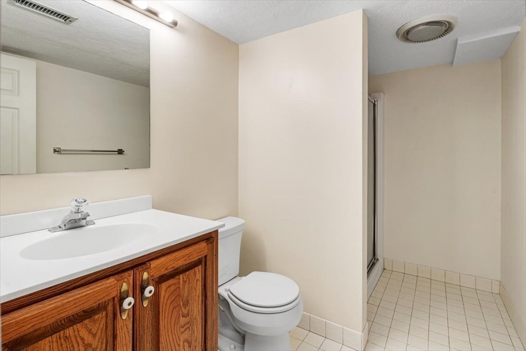74 Thistle Patch Way, Unit 74 Hingham, MA 02043 - Photo 19 of 22 a bathroom with a sink a toilet and a mirror