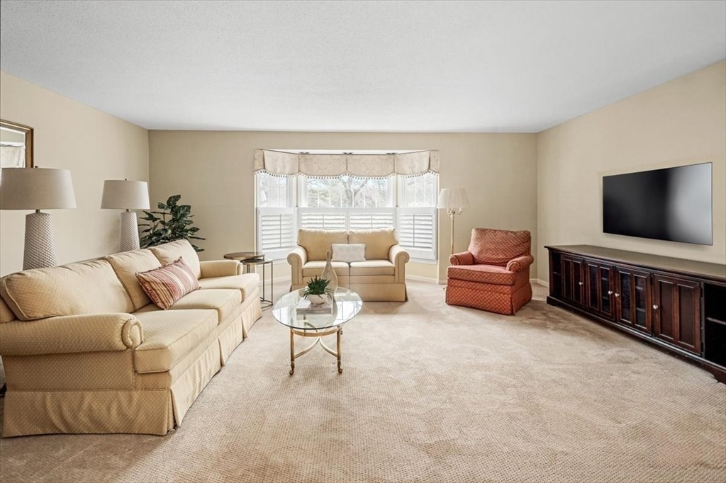 74 Thistle Patch Way, Unit 74 Hingham, MA 02043 - Photo 2 of 22 a living room with furniture and a flat screen tv