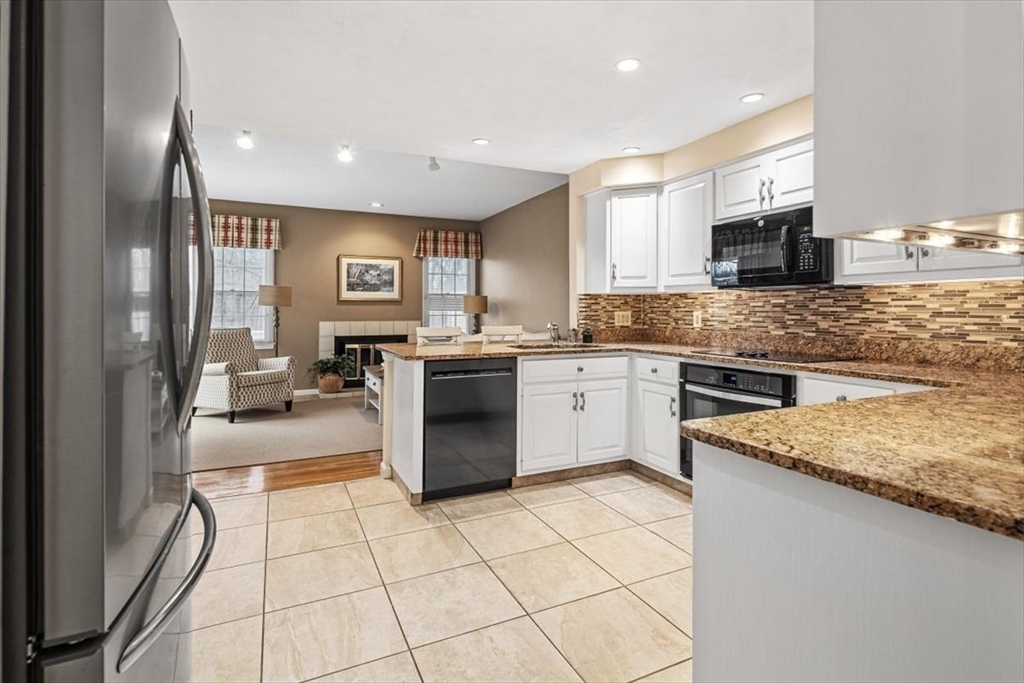 74 Thistle Patch Way, Unit 74 Hingham, MA 02043 - Photo 4 of 22 a kitchen with a sink a stove top oven and cabinets