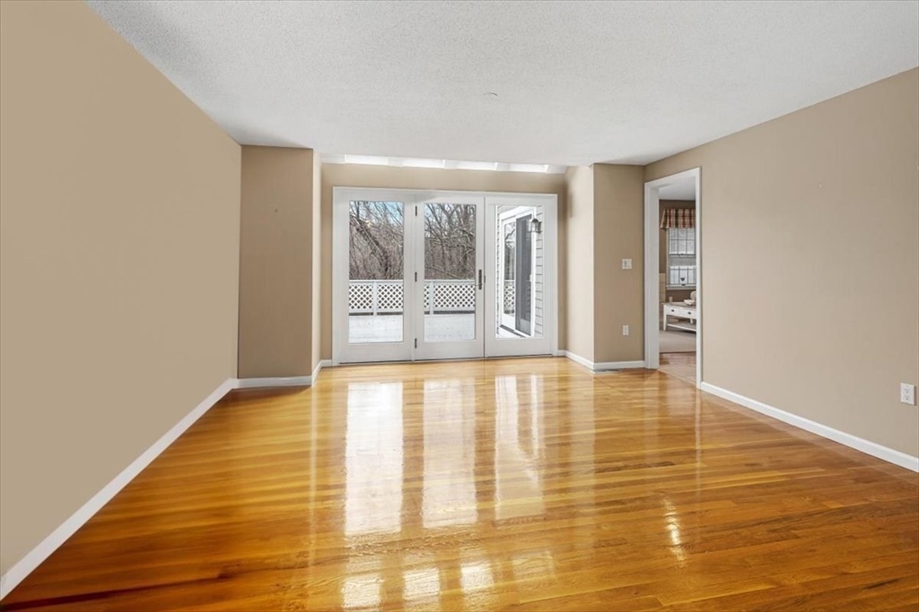 74 Thistle Patch Way, Unit 74 Hingham, MA 02043 - Photo 7 of 22 a view of an empty room with wooden floor and a window