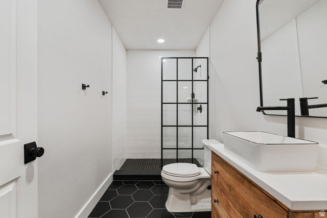 1002 South Yarrow Drive Mapleton, UT 84664 - Photo 35 of 39 Bathroom featuring a sleek black-framed shower enclosure, hexagonal black floor tiling, and a natural wood-finish vanity with a vessel sink
