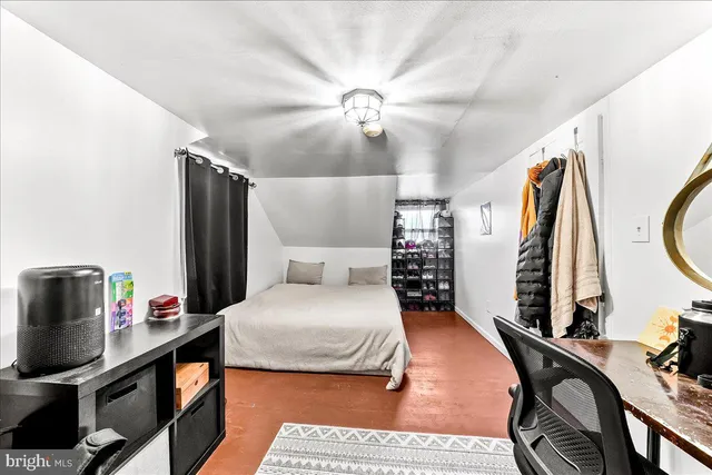 a bedroom with furniture and a flat screen tv