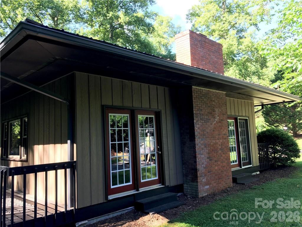 99999 Red Oak Forest Road Fairview, NC 28730 - Photo 6 of 8 a front view of a house with a garden