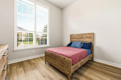 a bedroom with a bed and window