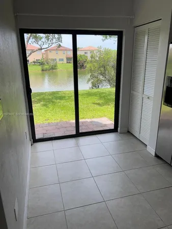 a view of a kitchen with an empty space and a window