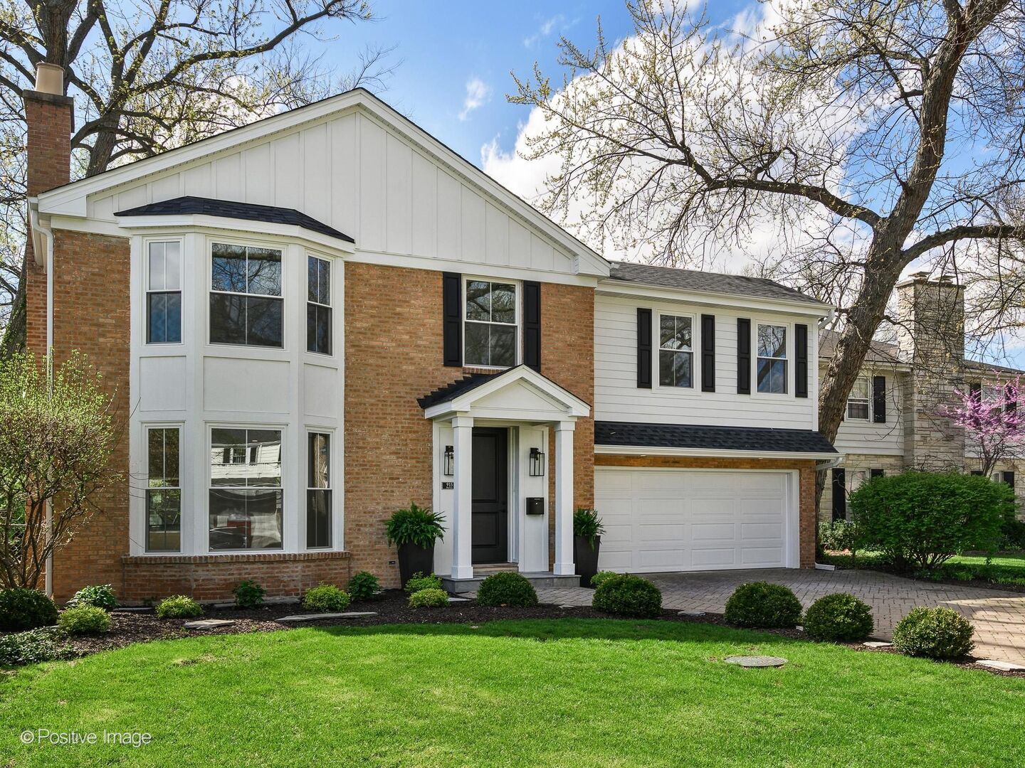 915 Pontiac Road Wilmette, IL 60091 - Photo 2 of 2 a front view of a house with a garden and plants