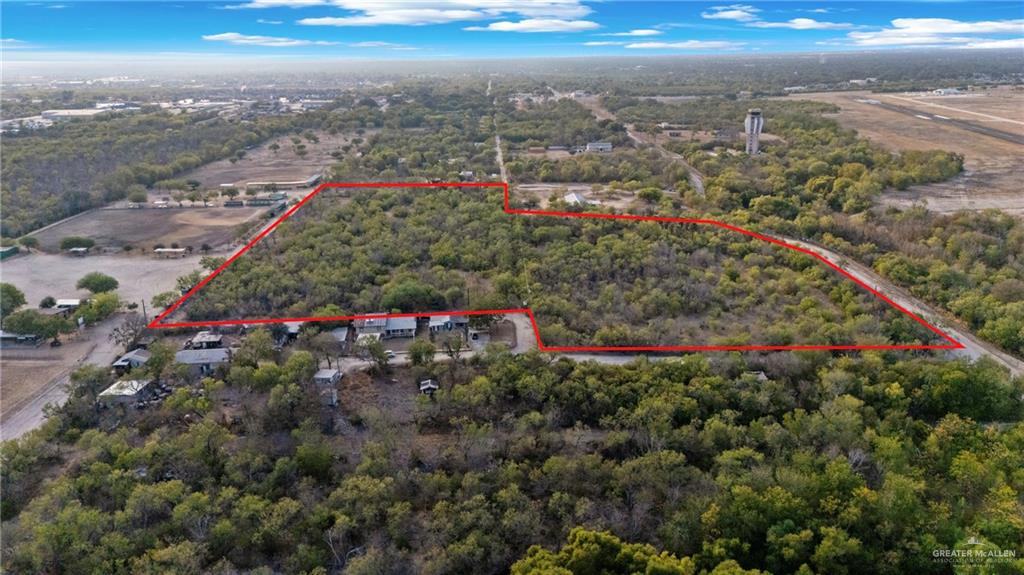1706 East Ashley Road San Antonio, TX 78214 - Photo 2 of 16 Expansive land parcel featuring dense tree cover and a surrounding rural landscape