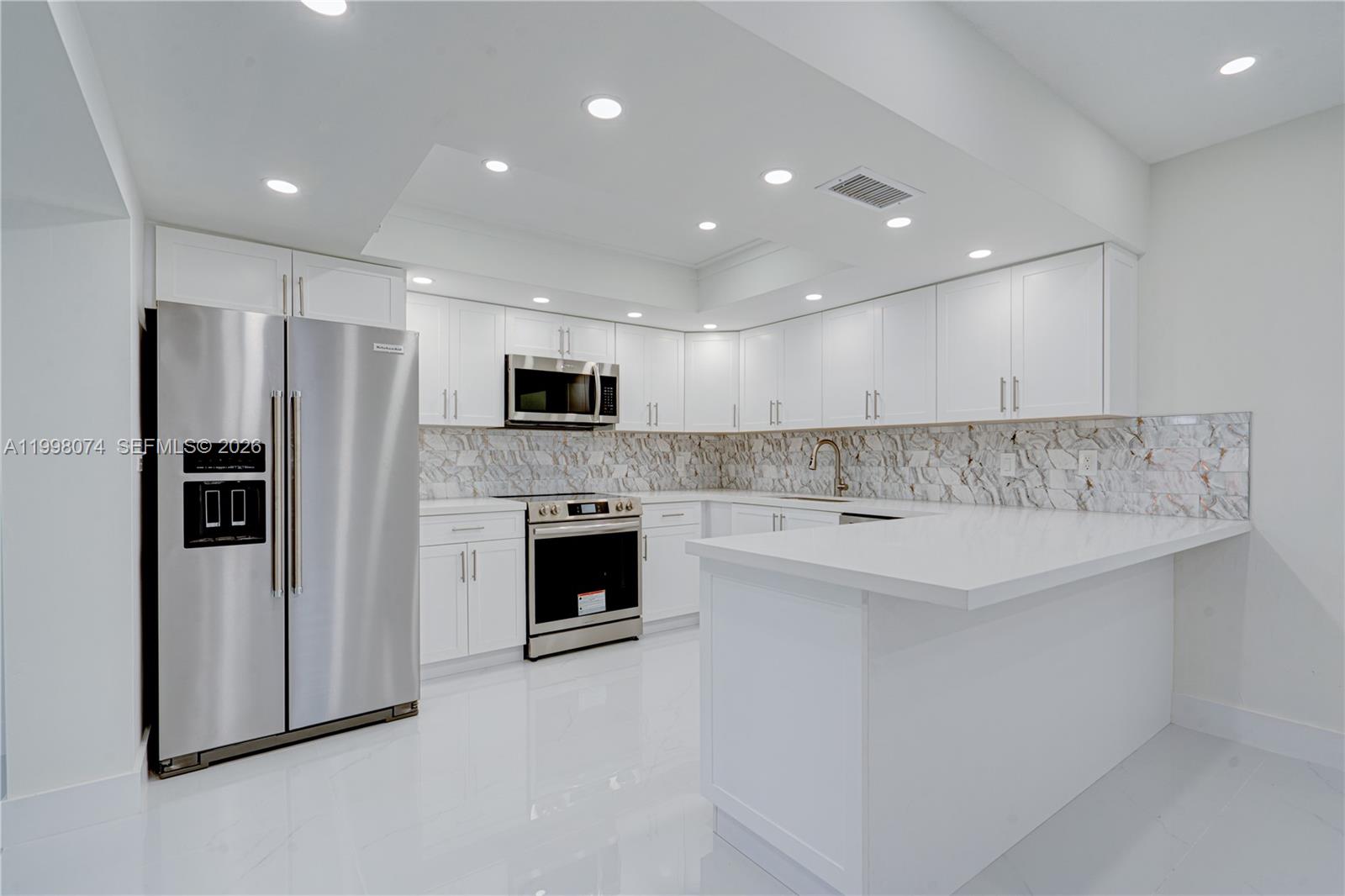 Pinecrest Pinecrest, FL 33156 - Photo 3 of 9 a large white kitchen with stainless steel appliances granite countertop a stove a refrigerator and a microwave