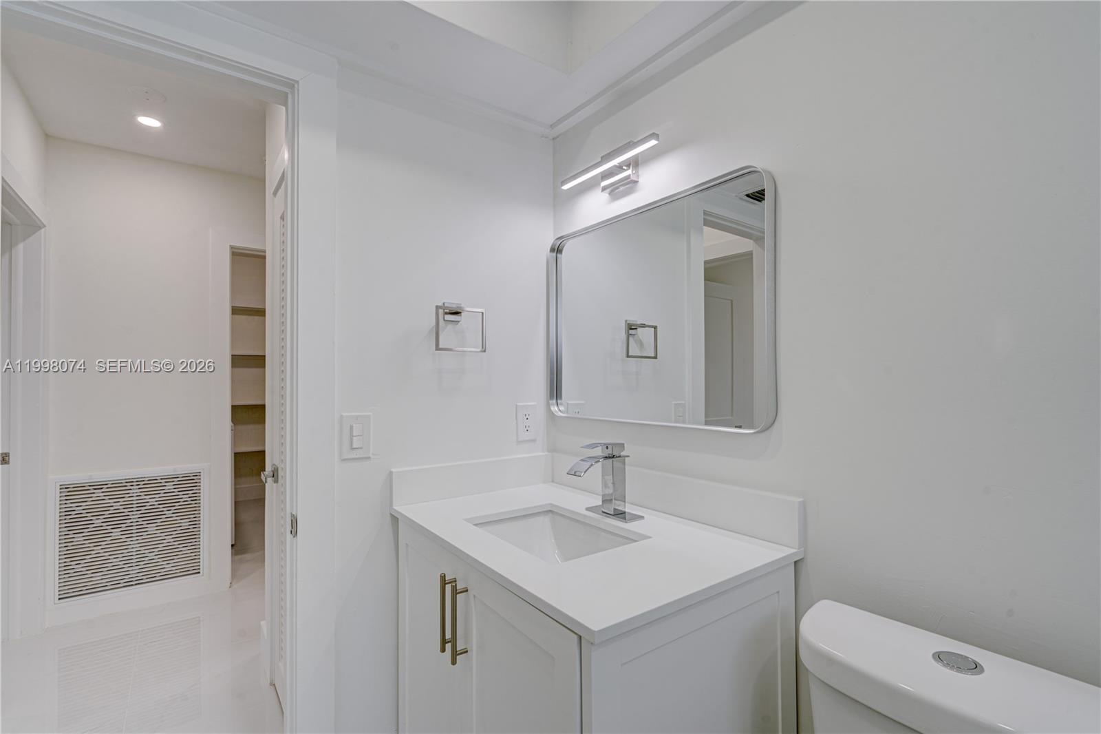 Pinecrest Pinecrest, FL 33156 - Photo 9 of 9 a bathroom with a sink toilet and mirror