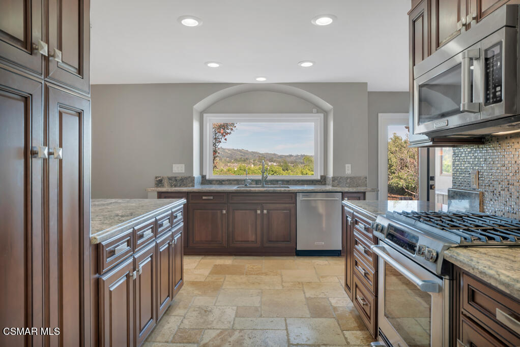 1660 San Rafael Way Camarillo, CA 93012 - Photo 17 of 63 a kitchen with a stove top oven sink and stainless steel appliances