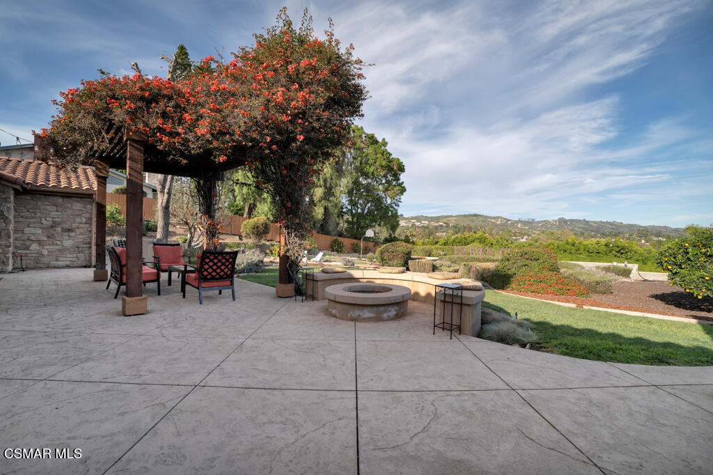 1660 San Rafael Way Camarillo, CA 93012 - Photo 39 of 63 a view of a patio with dining table and chairs with wooden fence