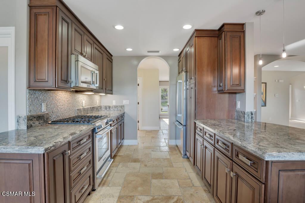 1660 San Rafael Way Camarillo, CA 93012 - Photo 6 of 63 a kitchen with granite countertop a sink a counter top space stainless steel appliances and cabinets