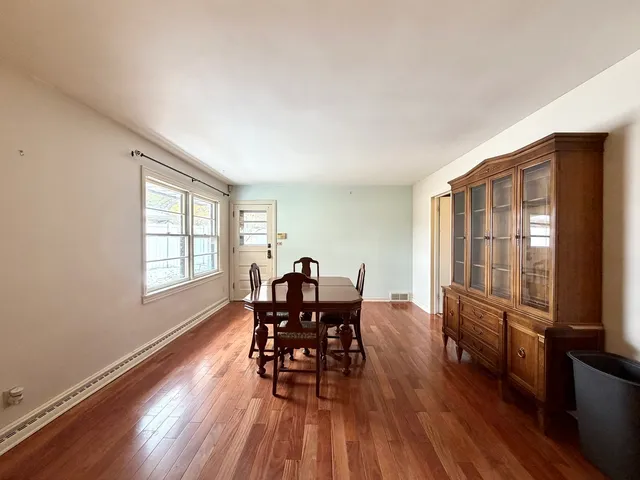 a dining room with furniture and wooden floor