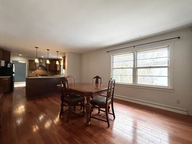 a view of a dining room with furniture and a large window
