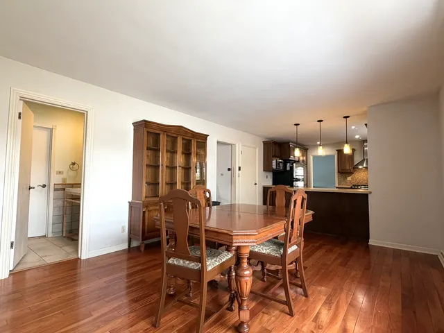 a dining room with furniture and wooden floor