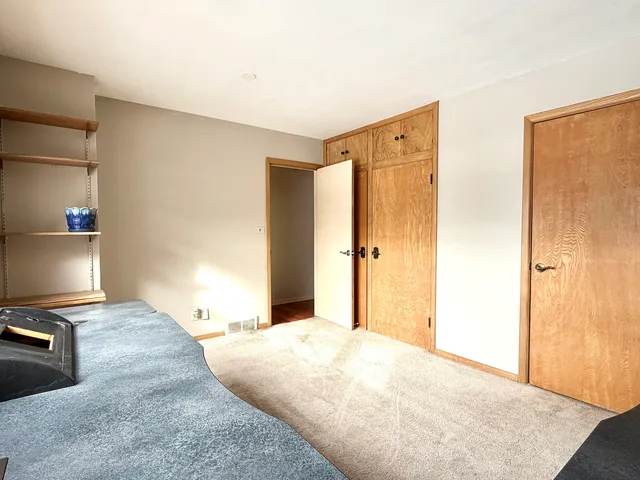 a bedroom with a bed and a television