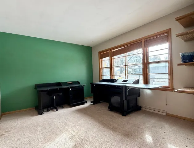 a room with a large window and furniture