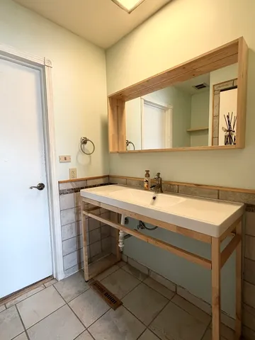 a bathroom with a sink and a mirror