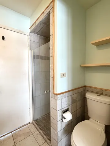 a white toilet sitting next to a bathroom sink