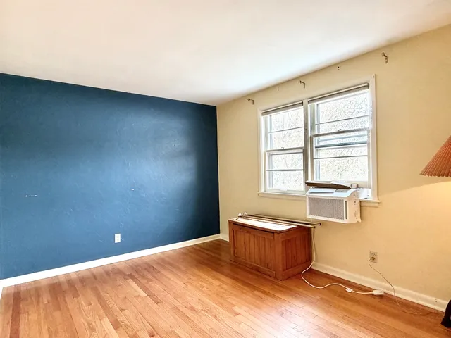 a spacious bedroom with a bed and a window