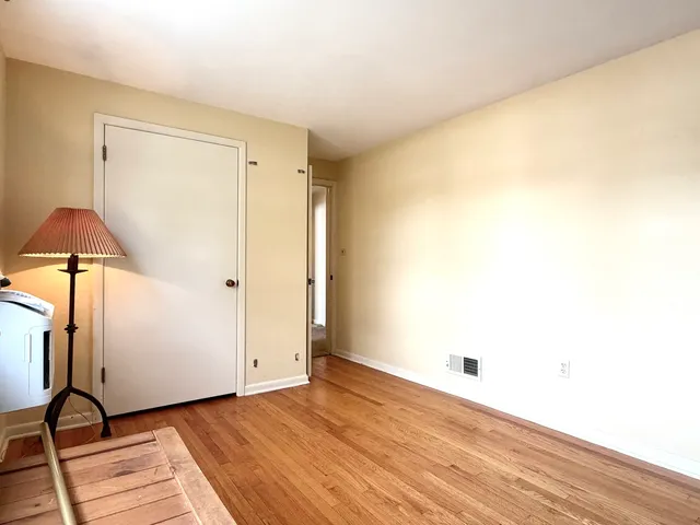 a view of a room with wooden floor