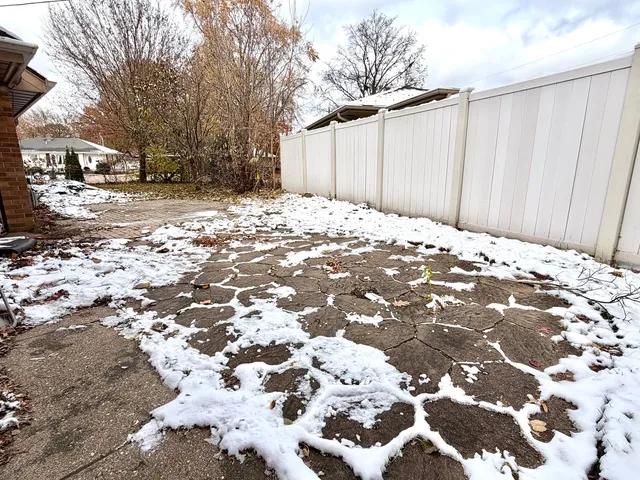a view of a yard with snow on the road