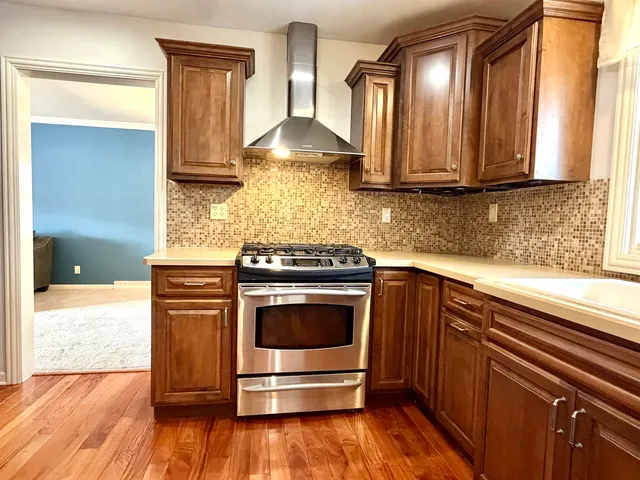 a kitchen with granite countertop a stove and a sink