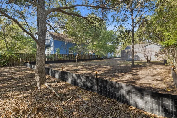 a backyard of a house with lots of trees