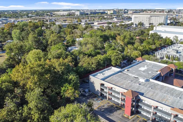 an aerial view of residential house with outdoor space and trees all around