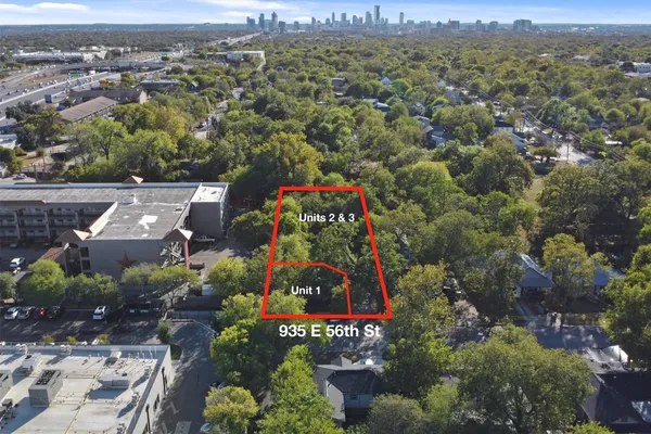 a view of dirt yard with a large tree