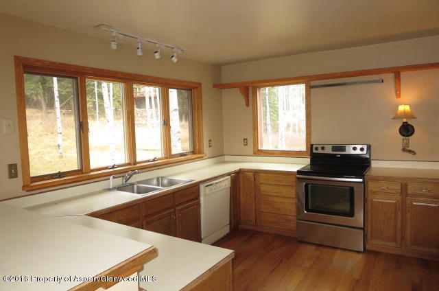 95 Chair Mountain Drive Redstone, CO 81623 - Photo 13 of 20 a kitchen with a sink stove and cabinets