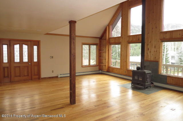 95 Chair Mountain Drive Redstone, CO 81623 - Photo 16 of 20 a view of an empty room with glass door and windows