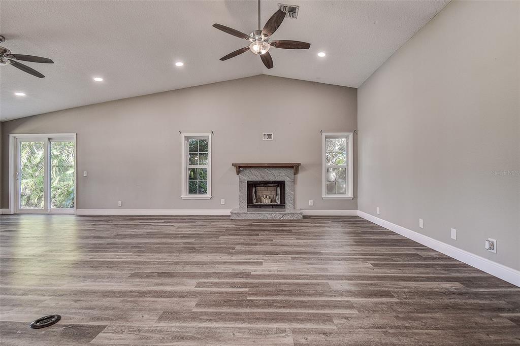 289 Whisper Lake Road Palm Harbor, FL 34683 - Photo 12 of 40 a view of an empty room with window and wooden floor
