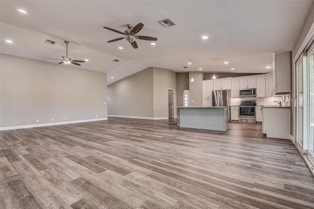 289 Whisper Lake Road Palm Harbor, FL 34683 - Photo 15 of 40 a view of a kitchen with a dishwasher and a stove top oven