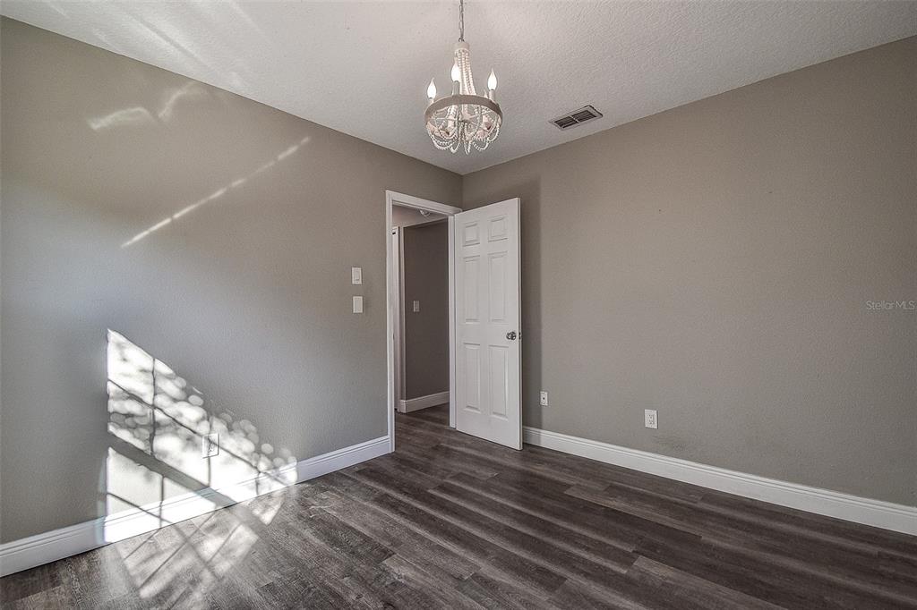 289 Whisper Lake Road Palm Harbor, FL 34683 - Photo 25 of 40 a view of an empty room with wooden floor